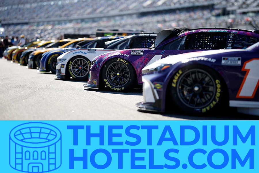 NASCAR speedway at night with lights and grandstands